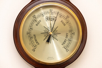 Close up of the face of an aneroid barometer