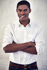 Comic, crazy and black man with arms crossed, funny face and portrait on white wall background in...