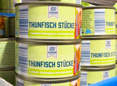Canned tuna display with german labels at seafood market shelf