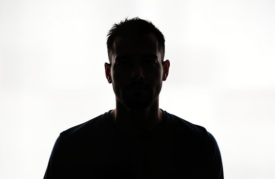 Silhouette of man. Serious male figure. Isolated against white background. Head, shoulders. Mystery, anonymity. Could used in various contexts like social media profiles, tech, business presentations - Powered by Adobe