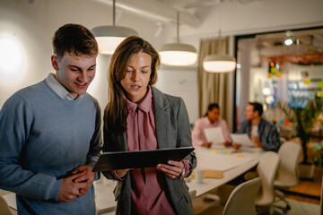 two colleague use together clipboard at office