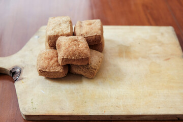 Tahu sumedang on wooden cutting board, is a typical sumedang tofu, west java which is brown and thick in it, served warm with chili.