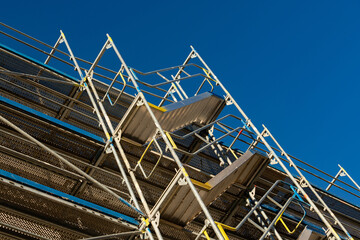 Contemporary scaffolding against a clear blue sky at construction site