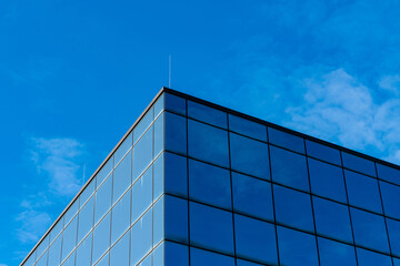 Modern building with glass facade under clear blue sky