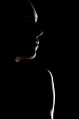 Silhouette of a Person in Profile with Artistic Lighting in Darkness