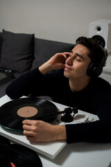 Listening rock vinyl album by turntable player. Vinyl record is playing a vintage vinyl album in...