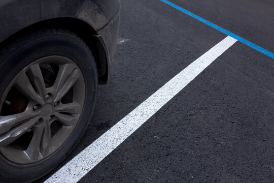 wheel against the background of parking lot markings - Powered by Adobe