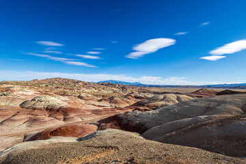 The colors of the otherworldly Bentonite Hills of Utah change and become more dramatic as the sun...