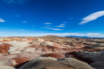 The colors of the otherworldly Bentonite Hills of Utah change and become more dramatic as the sun...