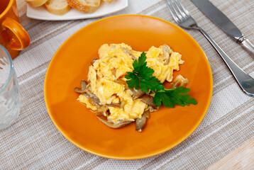 Wok-fried garlic mushrooms with scrambled eggs and fresh cream.