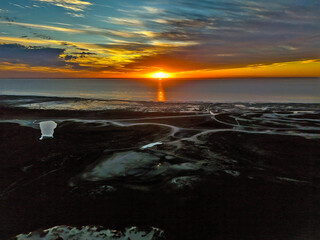 Aerial view of South Padre Island, looking towards the sunset, the Laguna Madre, sand dunes and...