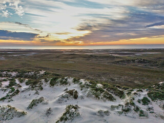 Aerial view of South Padre Island, looking towards the sunset, the Laguna Madre, sand dunes and wetlands.