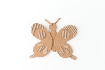 Creative eco-friendly cardboard butterfly craft for kids made from box cardboard. Fun DIY recycling project promoting sustainability, artistic expression, fine motor skill development ,
