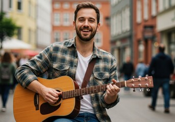 Obraz premium Smiling man playing guitar on city street in casual outfit