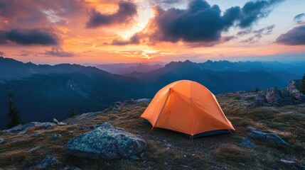 A bright orange tent set on a rugged mountain ridge beneath a strikingly dramatic evening sky, evoking adventure and natural beauty in every angle.