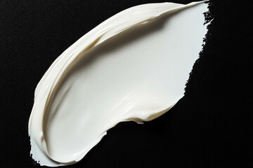 Smooth white cream texture spread on black background, ideal for beauty and skincare products showcasing richness and luxury in a minimalist style