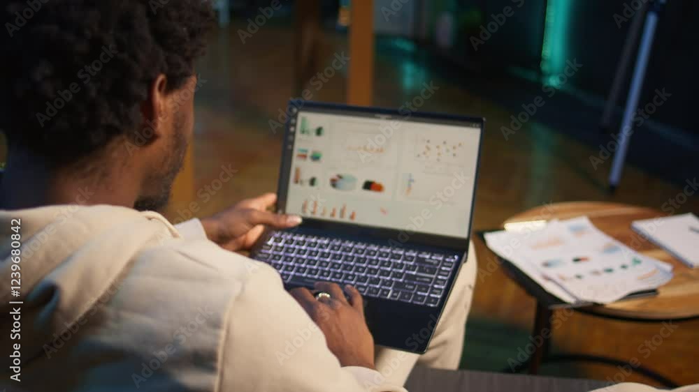 Poster african american freelancer working from home using financial graphs, reviewing statistical data to 