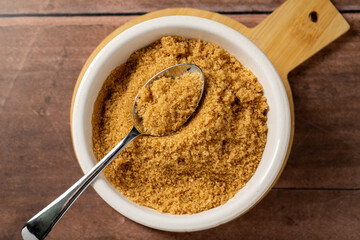 Light brown granulated sugar in a bowl. To view