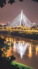 Obraz premium Illuminated Cable-Stayed Bridge Spans River at Night with City Lights Reflecting Beautifully