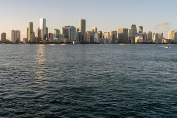Fototapeta premium Miami's stunning skyline at sunset, seen from across the calm waters of Biscayne Bay.