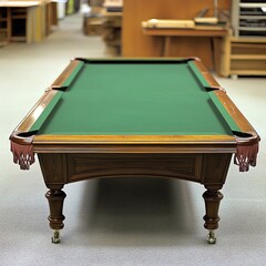 A classic billiard table with a green felt surface, featuring ornate wooden legs and details, set in a spacious room.