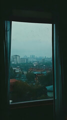 Fototapeta premium Rainy Cityscape Viewed Through a Window with Curtains Drawn Partially on a Gloomy Day