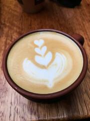 Latte art coffee being served in cusco cafe