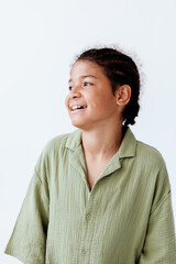Excited young boy in green shirt smiling and gazing up at the sky in anticipation