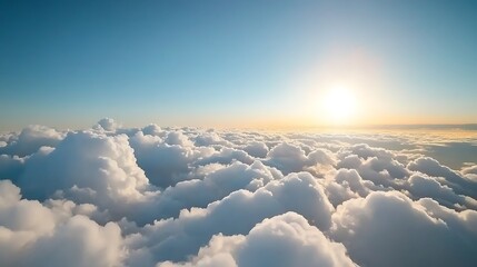 Serene aerial view of fluffy clouds illuminated by the warm glow of a sunrise over the horizon