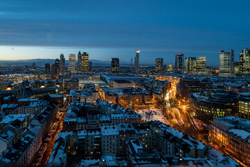 Frankfurt's captivating skyline at twilight, a stunning display of modern architecture under a snowy sky.