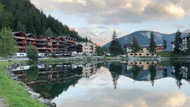 A serene evening at Champex-Lac, a picturesque alpine lake in the Valais region of Switzerland. The tranquil waters reflect the surrounding mountains, creating a breathtaking and peaceful atmosphere.