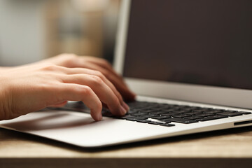 Businessman using laptop at table, closeup. Modern technology