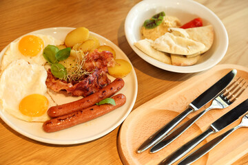 Delicious breakfast served on wooden table in restaurant, closeup