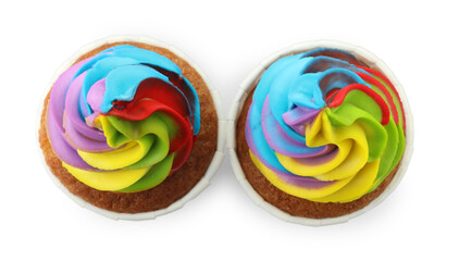 Tasty cupcakes with colorful cream isolated on white, top view