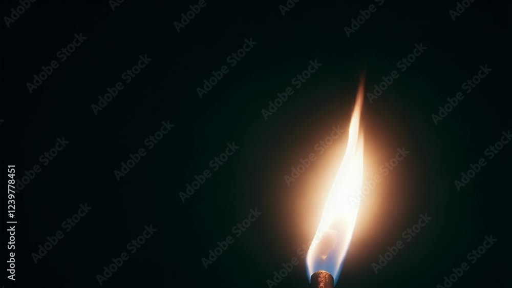 Poster orange flame burning brightly against deep black background, casting dynamic light and creating mesm