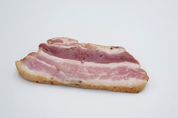 Pieces of salted lard with layers of meat on a white background. Sliced ​​bacon.