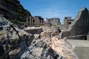 Fototapeta premium A haunting scene of crumbling concrete structures under a clear blue sky; remnants of a forgotten era, standing as silent witnesses to time's passage.