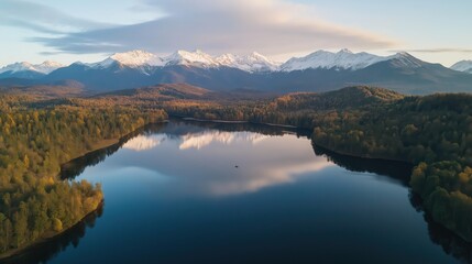 Obraz premium Autumn Lake Reflecting Snow Capped Mountains Under Sunrise