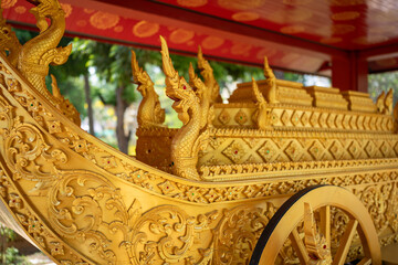Fototapeta premium A majestic golden carriage, adorned with intricate carvings and dragon accents, commands attention.