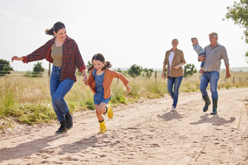 Family, generations and mother with girl, farm and walking for countryside, holiday and happy together. Woman, grandparents and child or daughter for vacation, bonding and love in rural environment © peopleimages.com