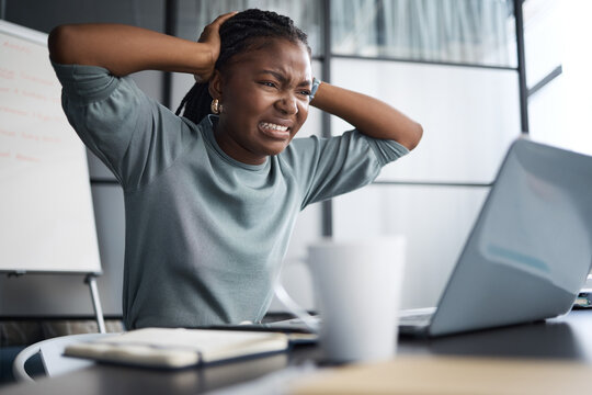 Black woman, laptop and frustrated with stress in office with anxiety, email or rejection letter for architecture deal. Person, computer and anger with crisis for news at property development agency
