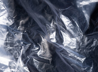 full frame abstract background of crumpled black plastic film bag