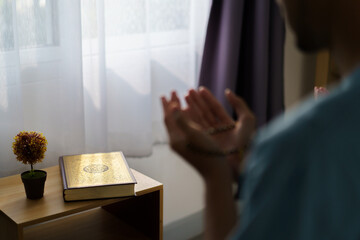 Asian muslim man and son are praying for Allah.