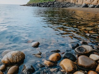 Obraz premium Serene Coastal Rocks Clear Water Smooth Stones Ocean View