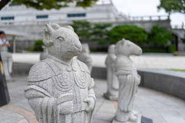A serene ram statue stands majestically among others in a peaceful park setting, showcasing...