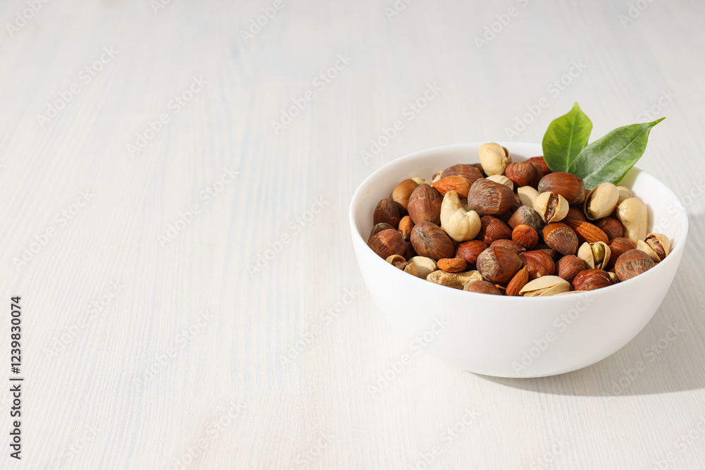 Wall mural Assorted nuts in white bowls on a light background