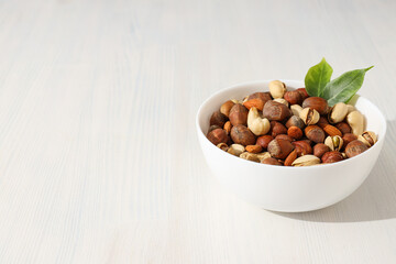 Assorted nuts in white bowls on a light background