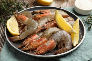 Fresh raw shrimps and spices on table, closeup