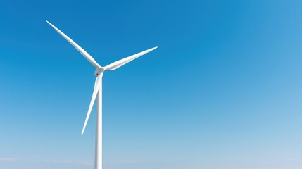 Fototapeta premium Wind turbine against clear blue sky, renewable energy