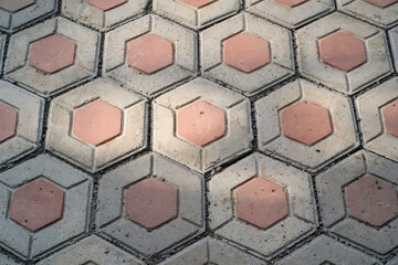 Textural backgrounds hexagonal paving blocks. Hexagonal bricks for flooring exposed to morning...